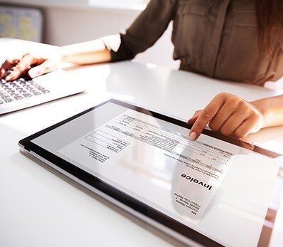 Person reviewing an IT service invoice for cost optimization and expense management.