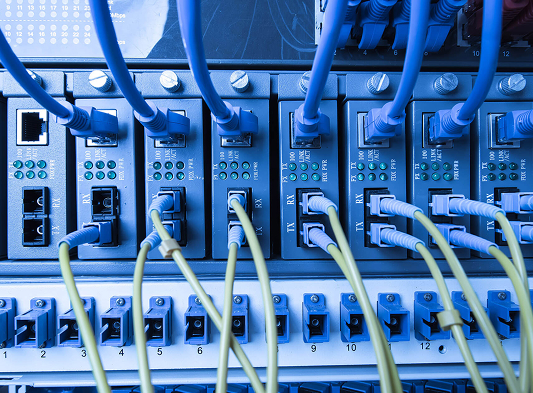 Network cables connected to a switchboard in a server room.