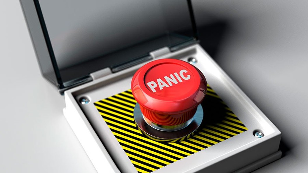 A red panic button with the protective case open